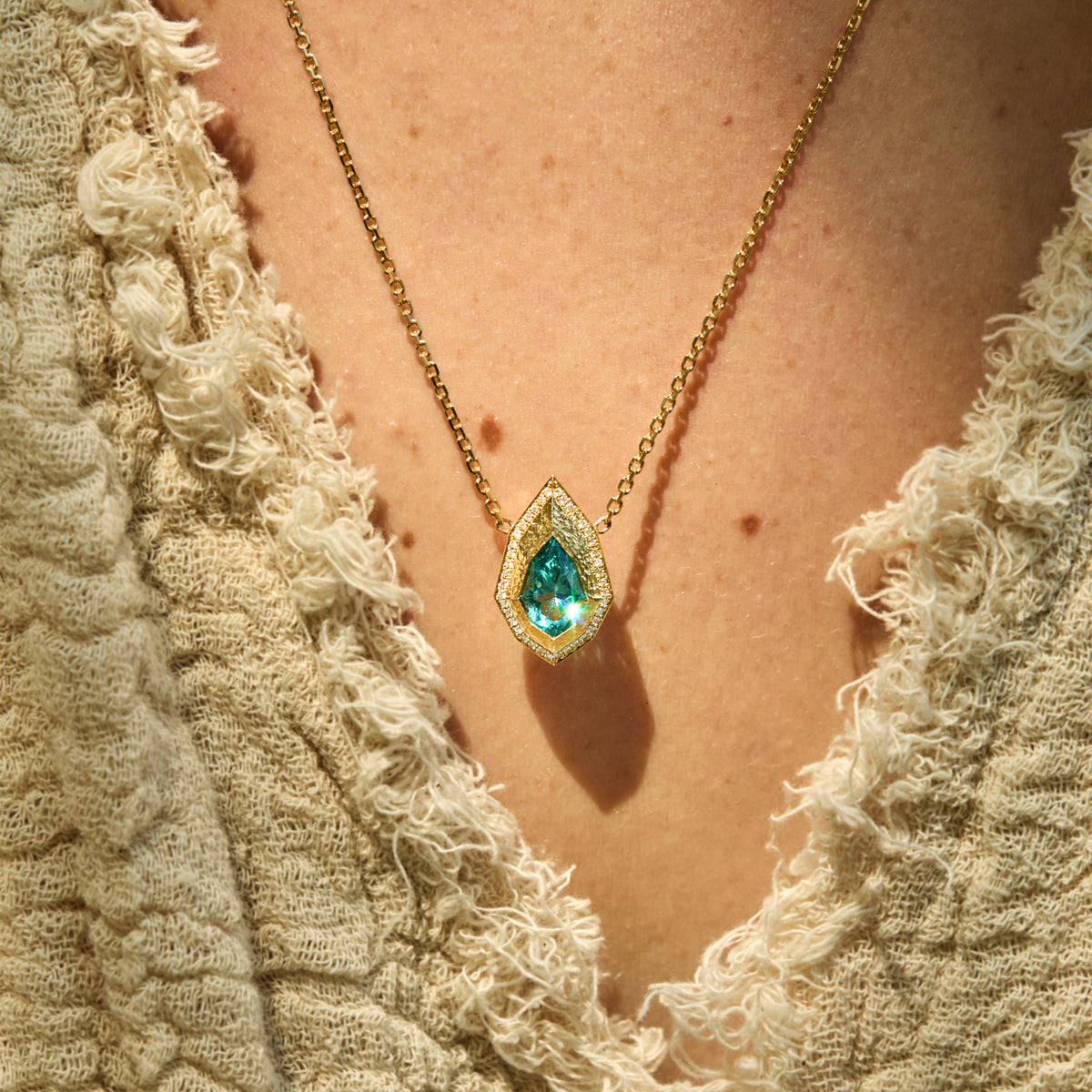 Pear-cut lagoon tourmaline necklace with natural diamond and hand-carved 14K yellow gold Art Deco Style on neck
