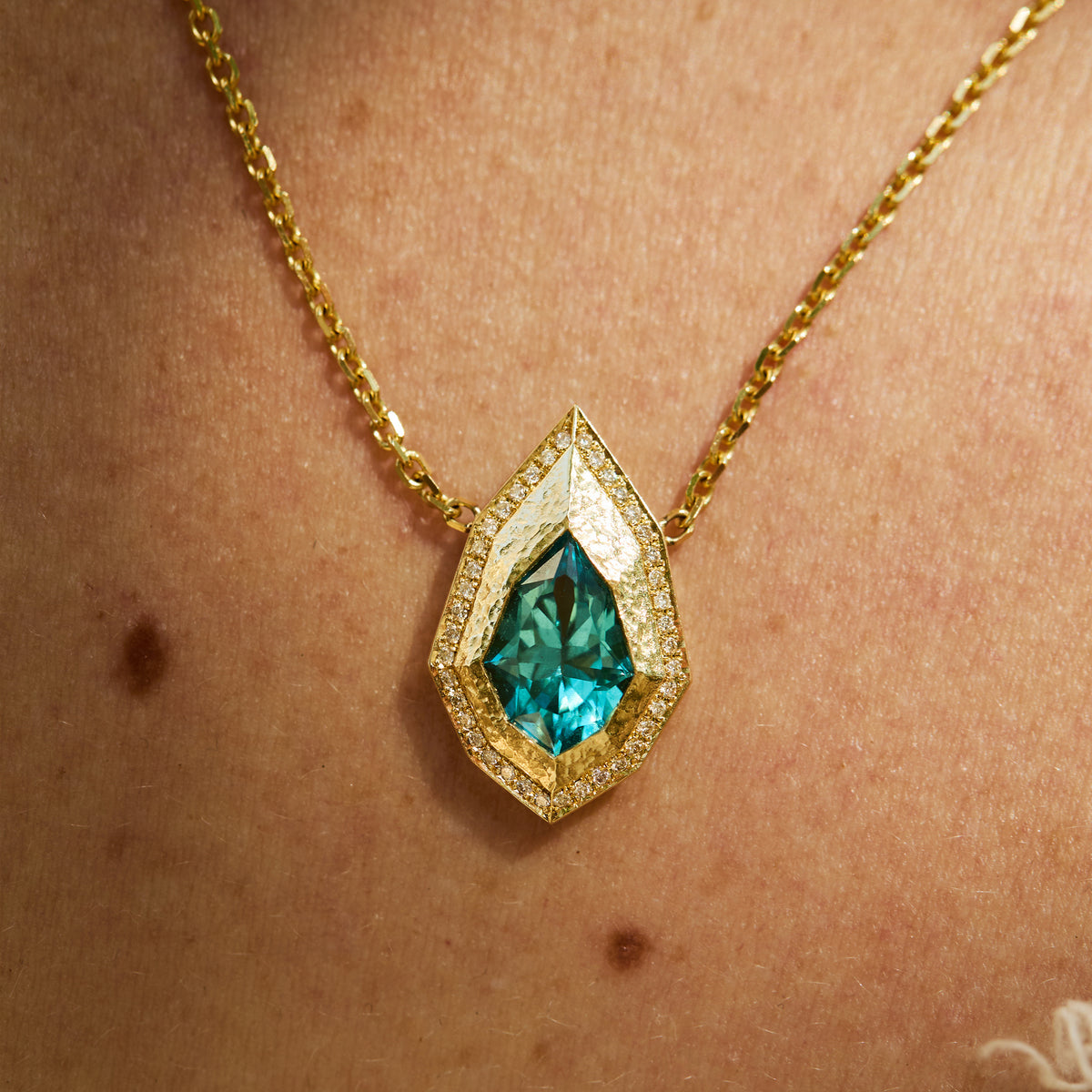 Pear-cut lagoon tourmaline necklace with natural diamond and hand-carved 14K yellow gold Art Deco Style on skin