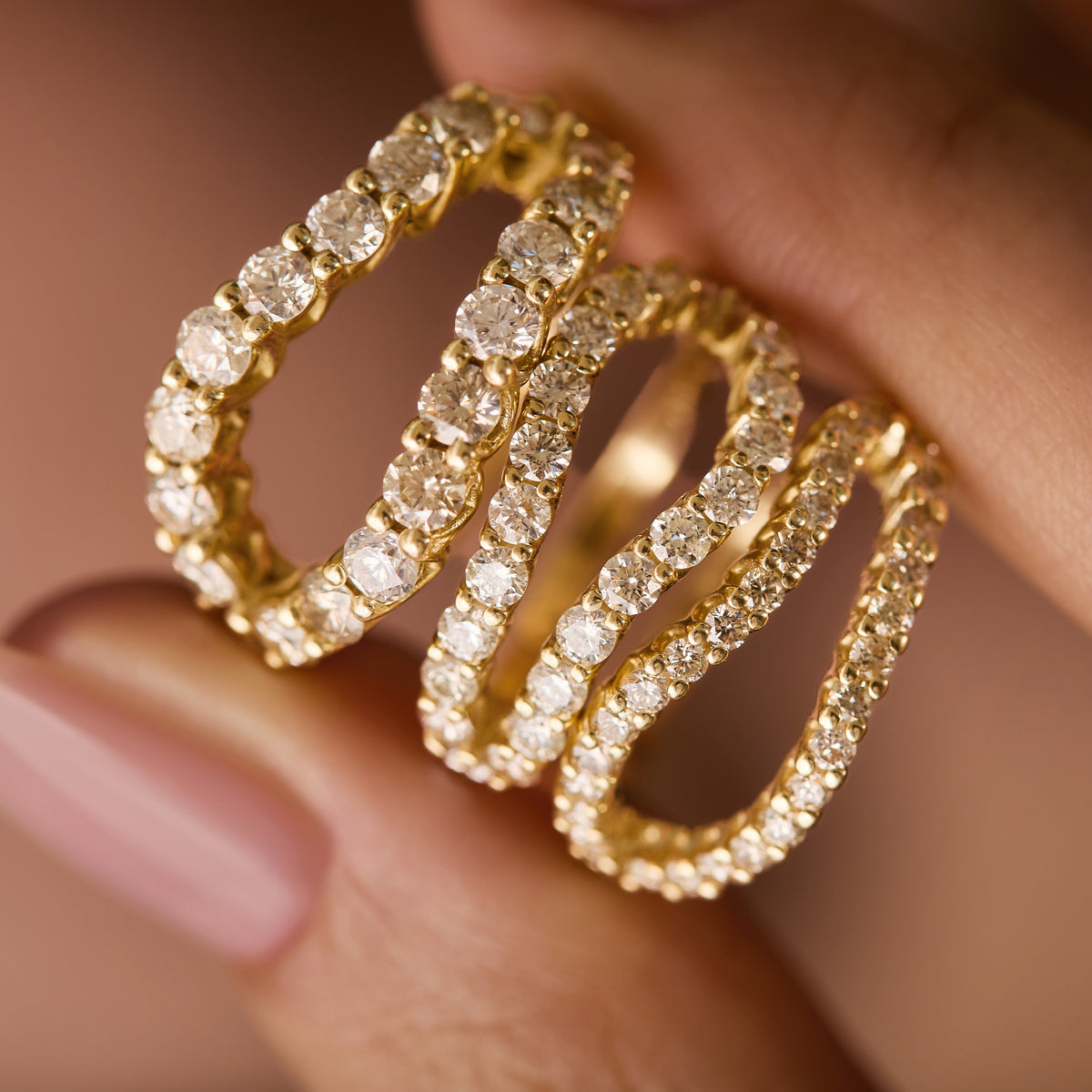 natural white diamond infinity rings in three sizes, bold, thin and original adama diamond infinity ring