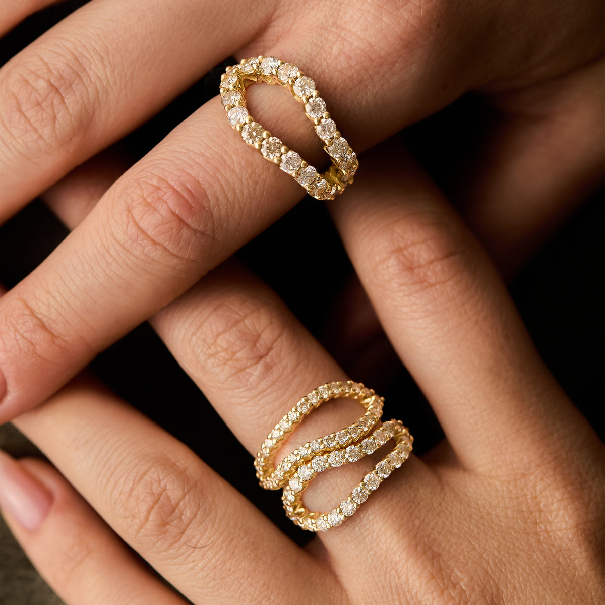 natural white diamond infinity rings in three sizes, bold, thin and original adama diamond infinity ring worn on hands