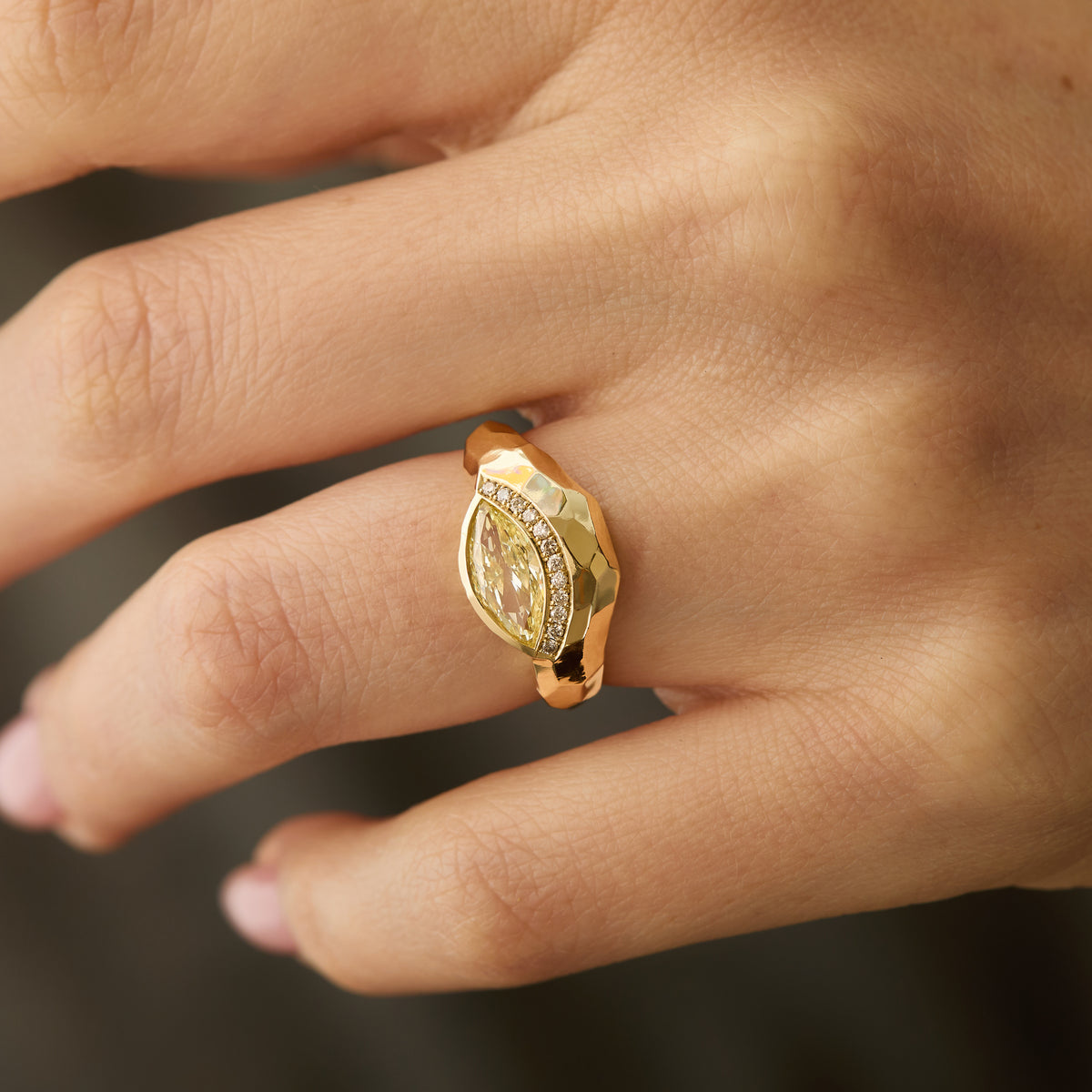 one-of-a-kind fancy yellow marquise diamond curve ring in 14K gold with white diamond pavé and hand-carved gold facets on hand