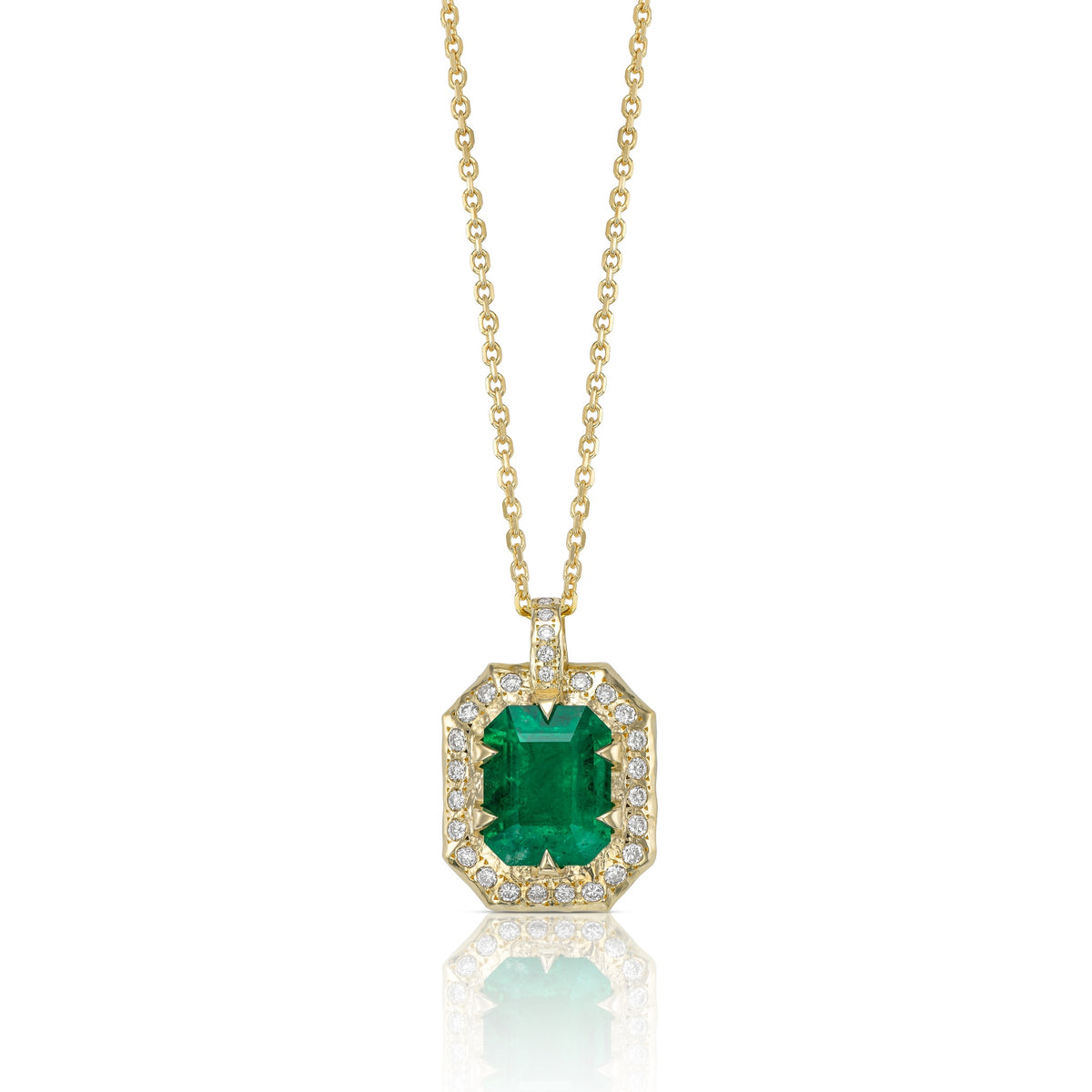 Emerald-cut natural emerald necklace with diamond surround and hand-carved 14K yellow gold pendant.