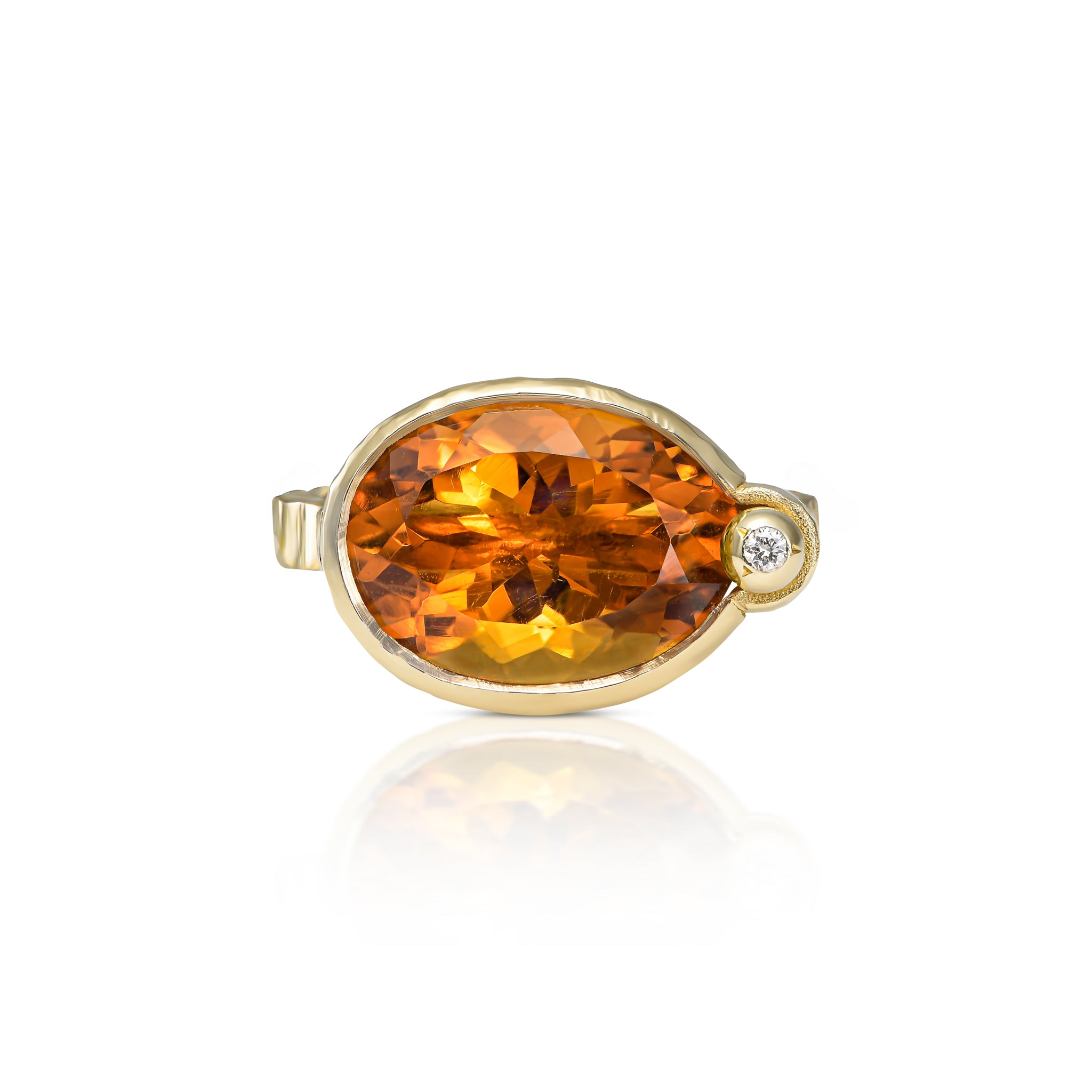 Front view of a bespoke oval citrine ring with sunset-orange color, natural diamond accent and sculptural 14K yellow gold setting.