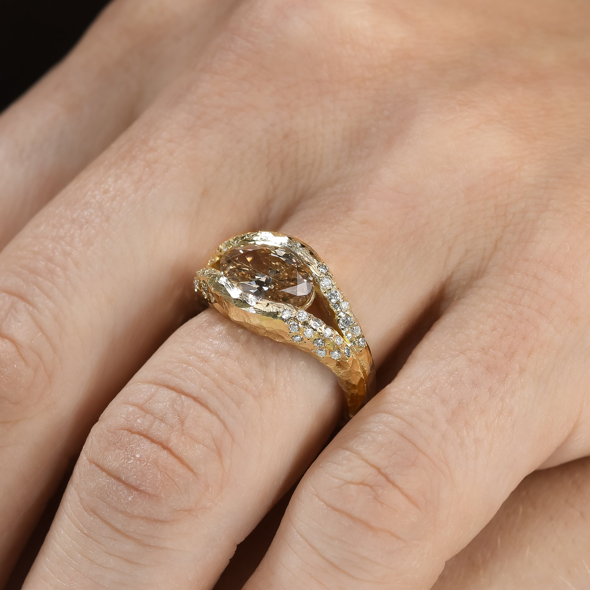 Discover the Annette Ring, featuring a 2 ct oval champagne diamond set in a luminous diamond halo. An alternative engagement ring handcrafted in 14K gold