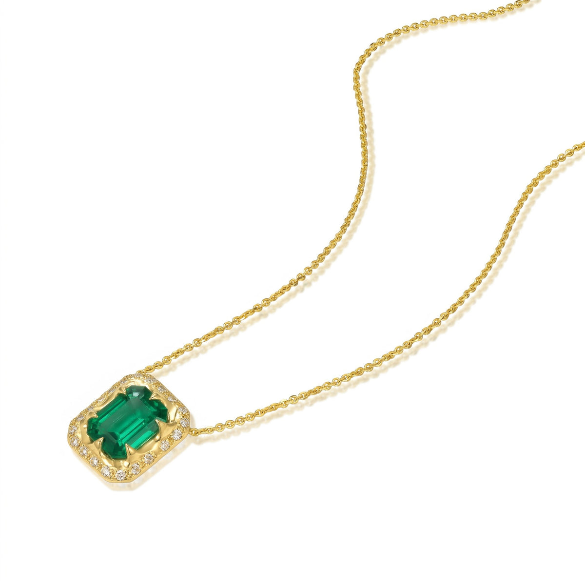 North-South emerald-cut emerald necklace with diamond halo, hand-carved 14K yellow gold pendant and fine gold chain.