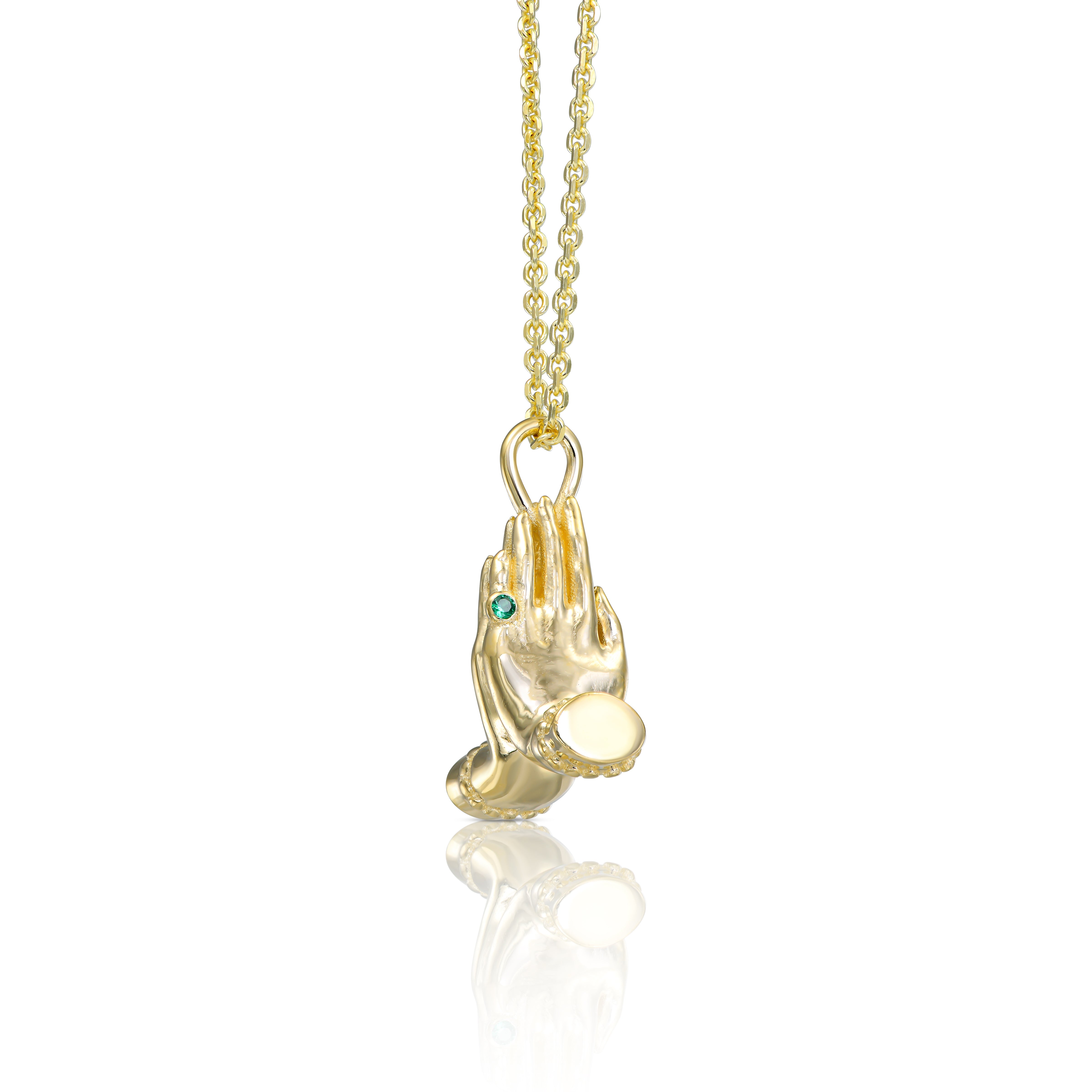 Side view of the Mini Namaste necklace showing the sculptural gold pendant and fine chain.