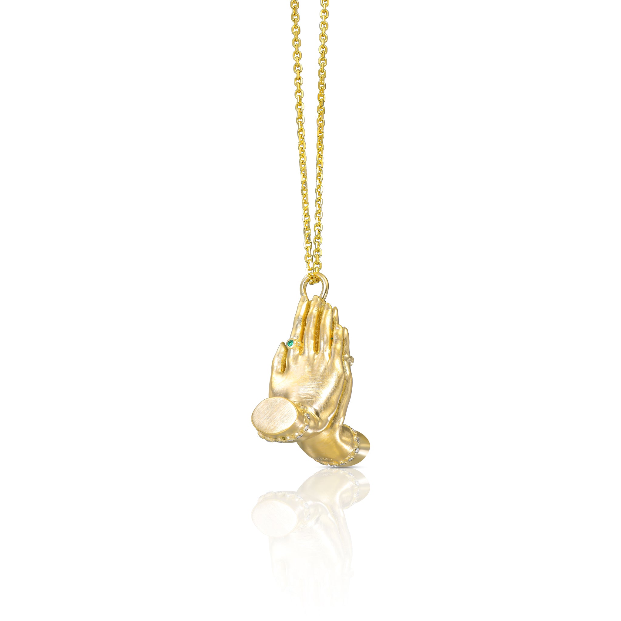 Side view of the Namaste gold necklace highlighting hand-carved texture and natural diamond accents.