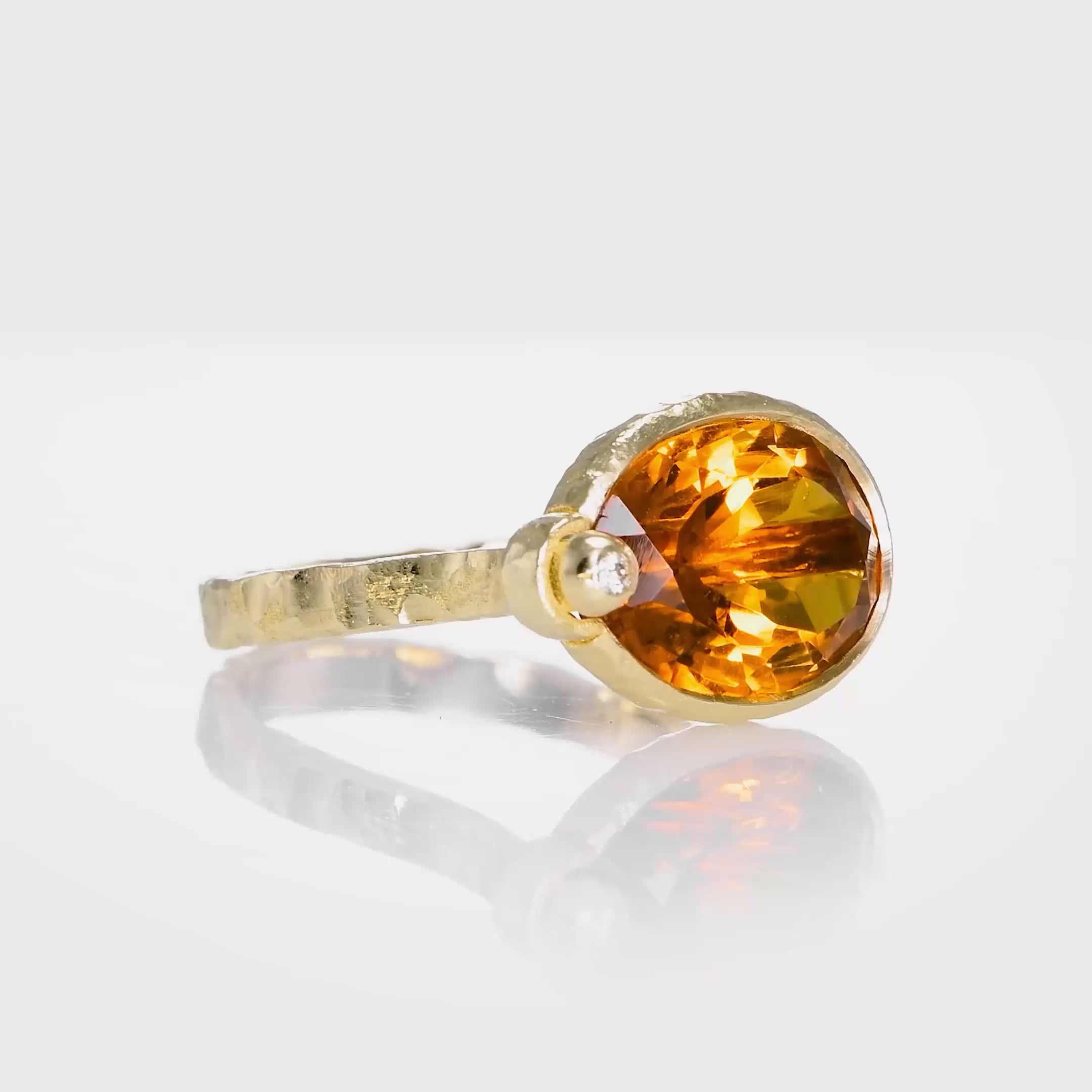 Shir’s bespoke oval citrine ring with vivid sunset-orange hues, diamond accent and hand-carved 14K yellow gold shown from multiple angles.