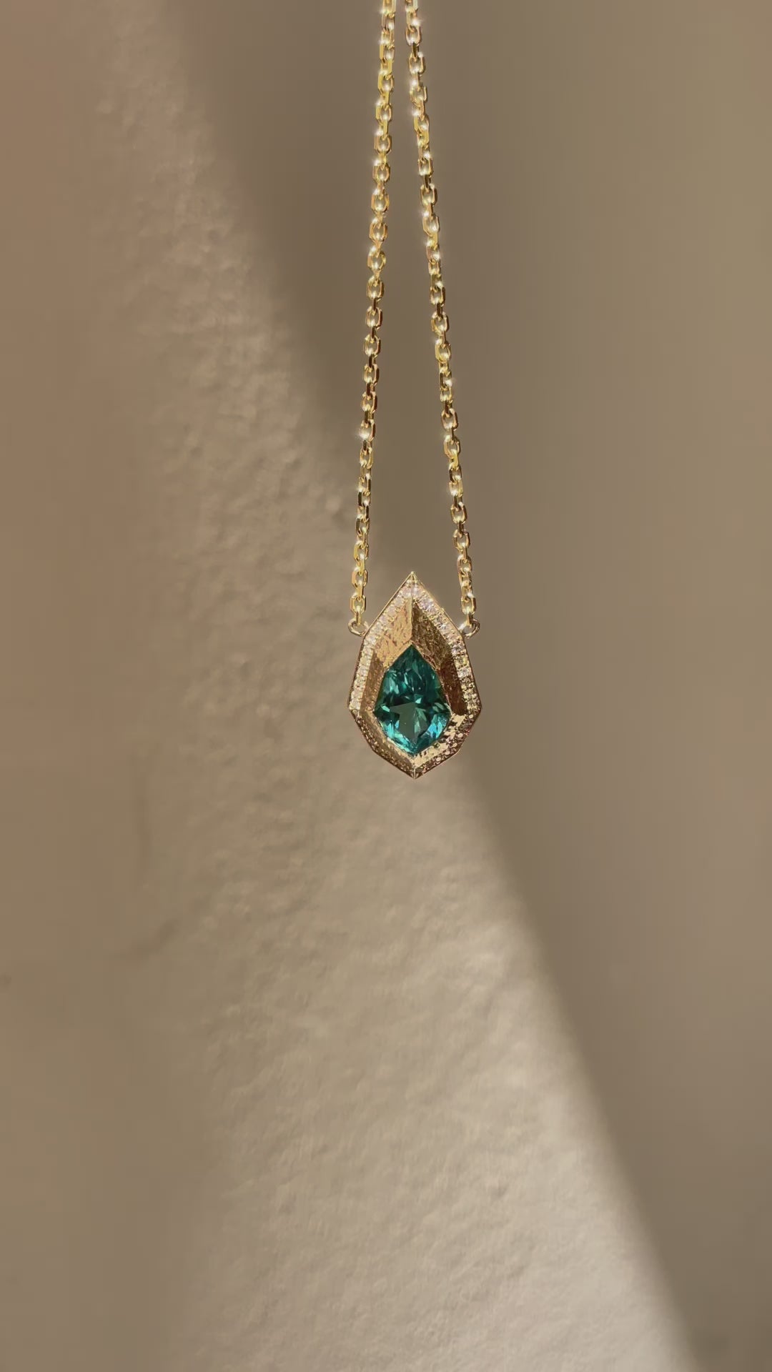 Pear-cut lagoon tourmaline and natural diamond necklace in hand-carved 14K yellow gold, featuring an Art Deco inspired geometric pendant.
