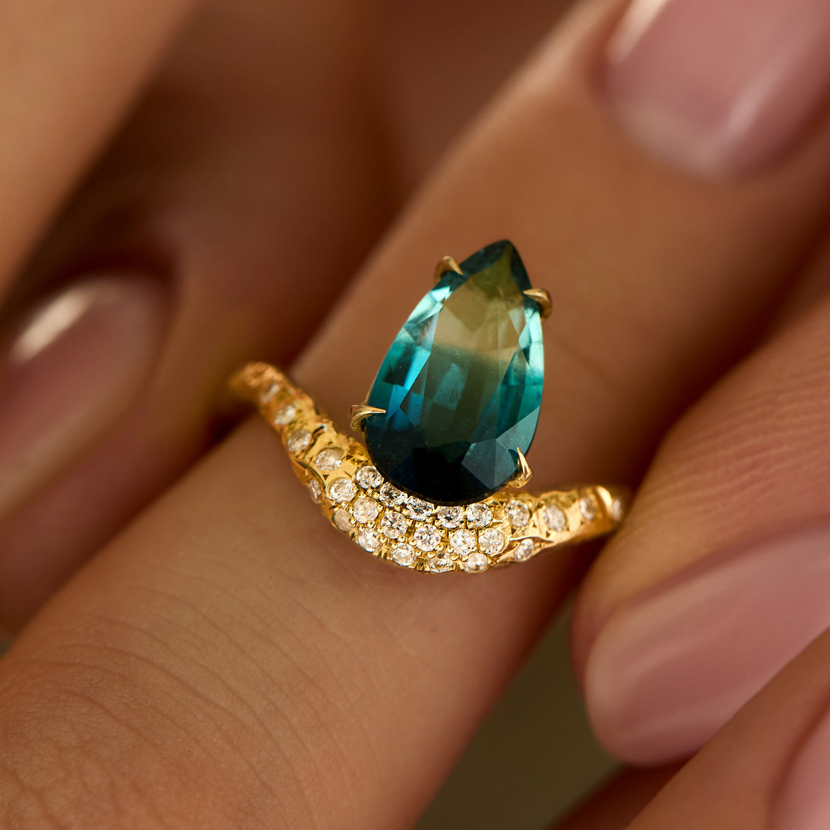 14K gold Wave ring with 2.42ct pear-cut teal tourmaline and a diamond halo, on finger